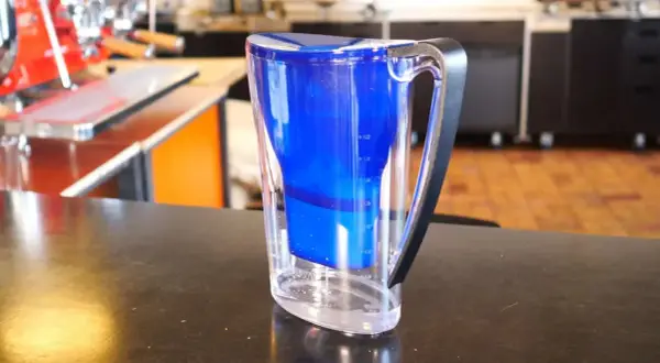 Blauer Wasserfilterkrug mit klarem Wasser. Perfekt für die Zubereitung von aromatischem Kaffee.