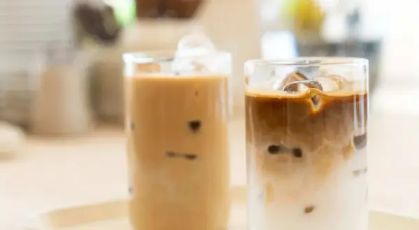 Zwei Gläser mit erfrischendem iced latte, gefüllt mit Eiswürfeln und cremiger Milch.