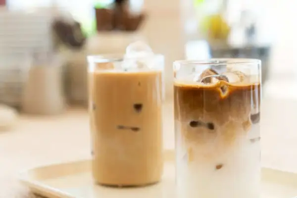 Zwei Gläser mit erfrischendem iced latte, gefüllt mit Eiswürfeln und cremiger Milch.